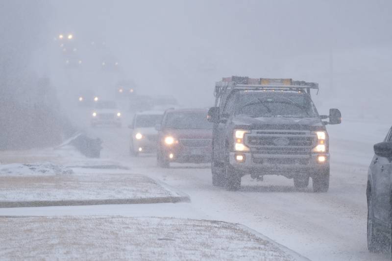 Traffic moves slowly along Plainfield Road due to slick road conditions and low visibility as the snow hits Joliet at the start of the evening rush hour. Thursday, Feb. 17, 2022, in Joliet.