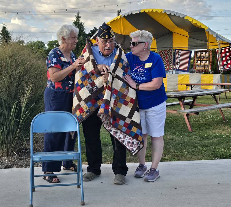 Dominic Rivara is presented with a Quilt of Valor on Sunday, Sept. 15, 2024, at Senica Square in Oglesby.