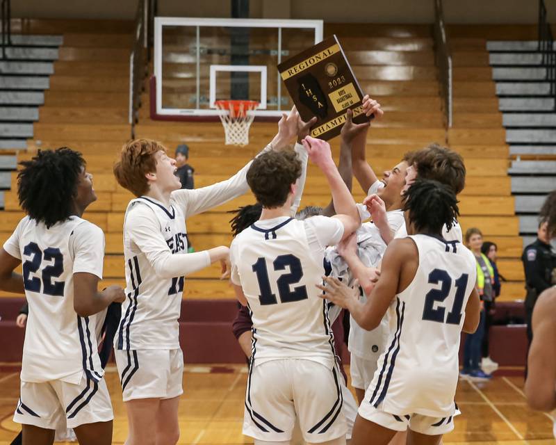 Oswego East celebrates with the Class 4A Lockport Regional final game plaque after defeating West Aurora.  Feb 24, 2023.