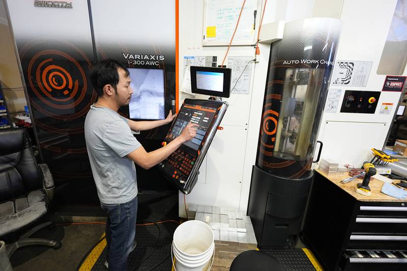 FILE - A worker at Reata Engineering and Machine Works programs a Mazak Variaxis machine used to make semiconductor pieces on Feb. 15, 2024, in Englewood, Colo. On Friday, June 7, 2024, the U.S. government issues its May jobs report. (AP Photo/David Zalubowski, File)