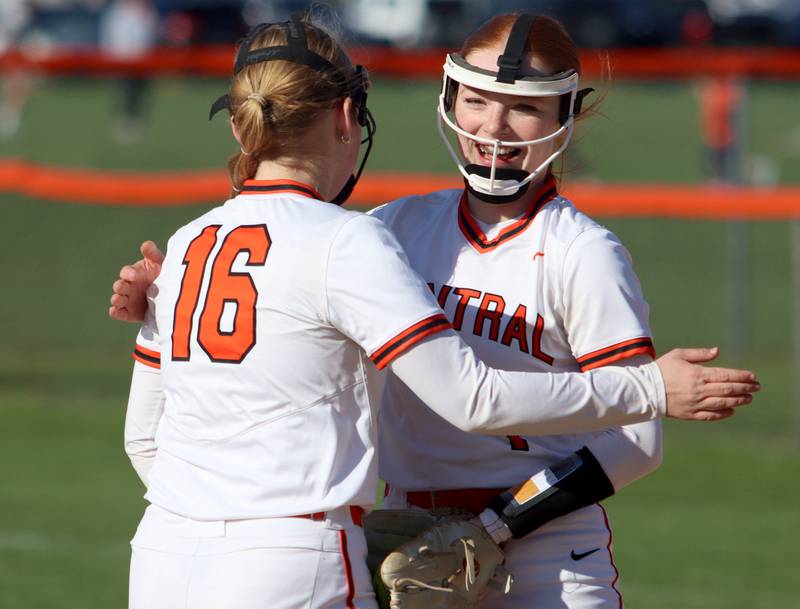 Crystal Lake Central’s Makayla Malone, right, congratulates Cassidy Murphy (16) after Murphy made a grab on a hot shot at third base against Woodstock North in varsity softball at Crystal Lake Friday.