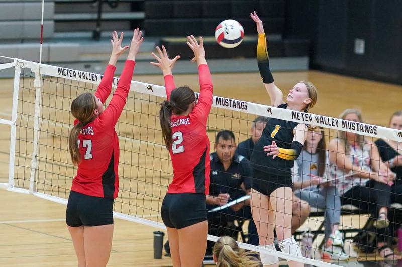 Metea Valley's Ashley Ward (1) goes up for a kill attempt against Benet’s Keira O’Donnell (17) and Gabriele Stasys (2) during a volleyball match at Metea Valley High School in Aurora on Wednesday, Sep 4, 2024.