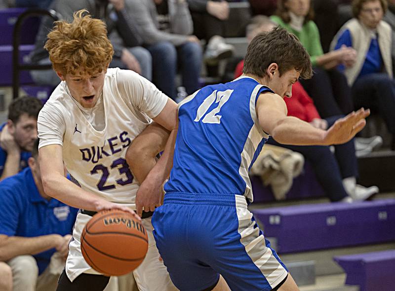 Dixon’s Austin Hicks gets tangled up with Princeton’s Tyson Phillips Thursday, Dec. 21, 2023 at Dixon High School.