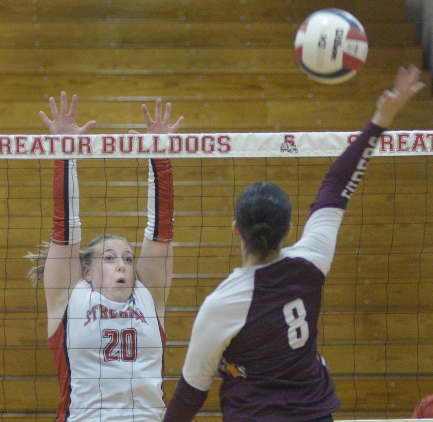 Streator senior Madelyn Martin sets to block a volley by East Peoria’s Addison Billingsley during the first set Monday at Streator.