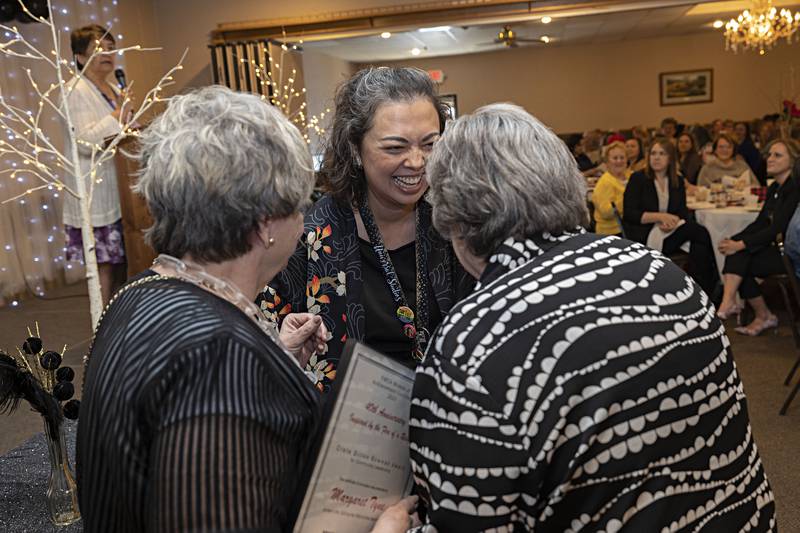 Nicole Oberg (center) is congratulated by Margaret Tyne and Eileen Piper after being named the recipient of the Crete Dillon Bowman Award for Community Leadership Thursday, April 13, 2023 at the YWCA Women of Achievement Luncheon. This is the 40th year of the luncheon recognizing women throughout the Sauk Valley.