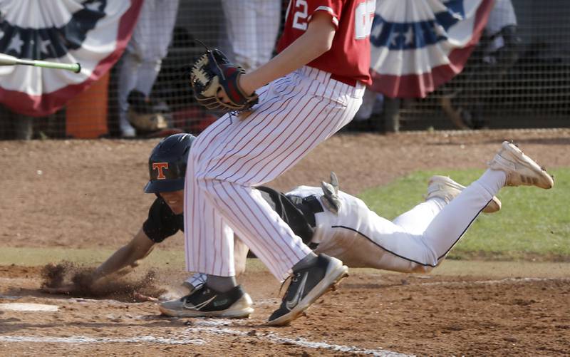 Crystal Lake Central's John Dobbeck dives to home plate to score a run after a wild pitch during a Class 3A Grayslake Central sectional championship baseball game on Friday, May 31, 2024, at the Grayslake Central High School.