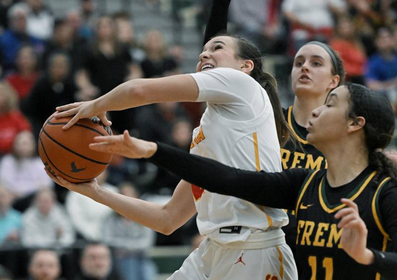 Batavia’s Brooke Carlson shoots around Fremd’s Coco Urlacher in the Bartlett supersectional game on Monday, Feb. 26, 2024.