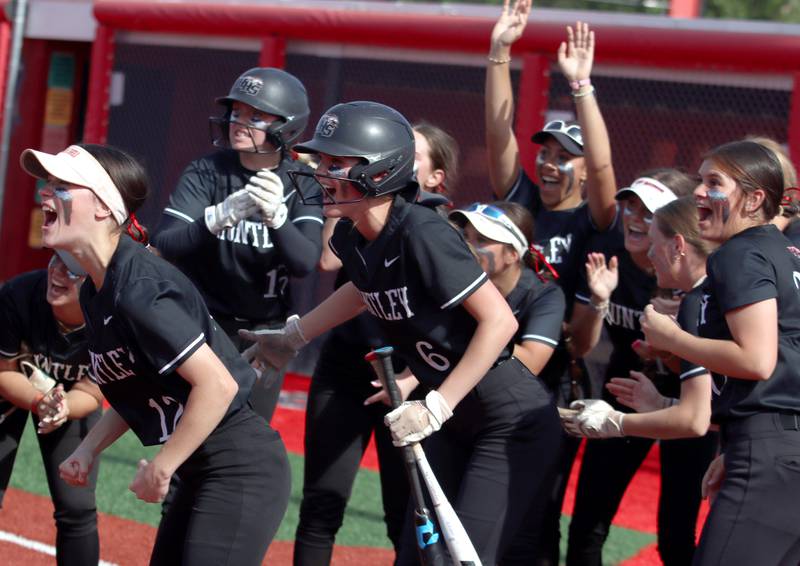 Huntley’s Red Raiders greet Meghan Ryan on her home run against Barrington in sectional final softball  action at Barrington Friday.