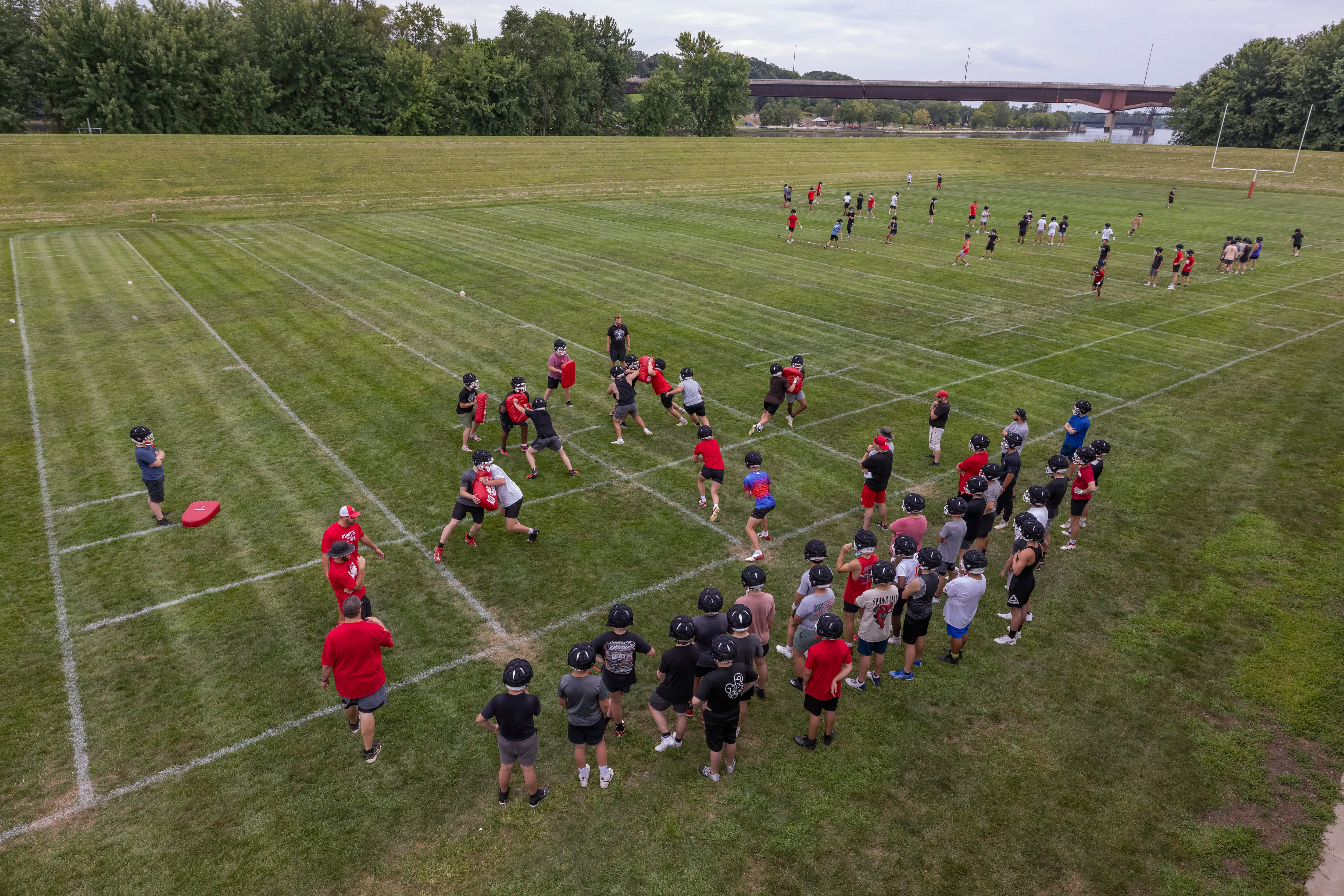 Ottawa High School football players run various drills across the field on opening practice day of football season at Ottawa High School on August 12, 2024.