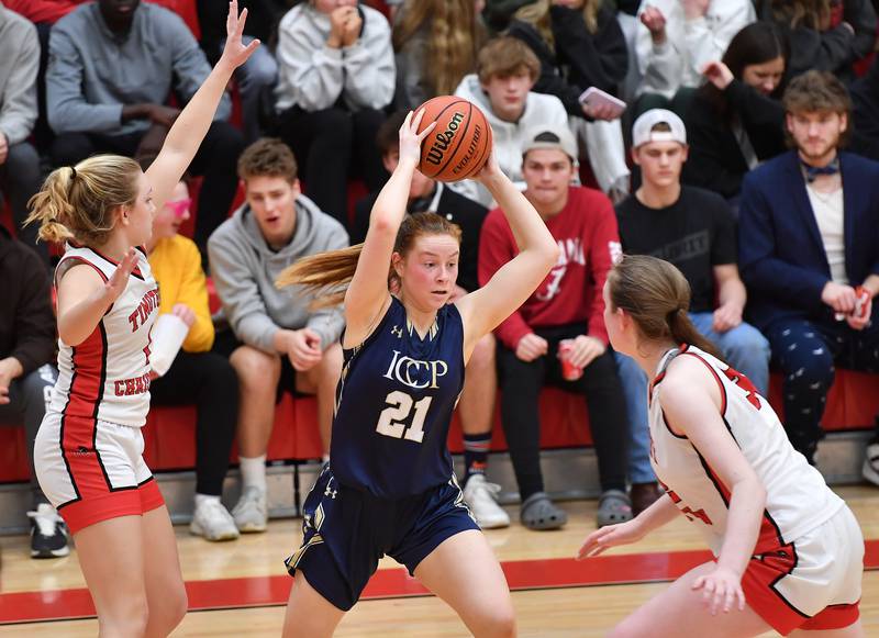 IC Catholic's Maura Grogan (21) starts to pass while double teamed by Timothy Christian during the Class 2A Timothy Christian Regional championship game on Feb. 17, 2023 at Timothy Christian High School in Elmhurst.