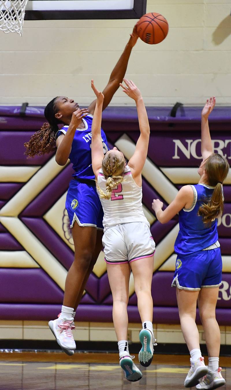 Lyons Township's Nora Ezike (left) blocks a shot by Downers Grove North's Hope Sebek (2) during a game on Jan. 30, 2024 at Downers Grove North High School in Downers Grove .