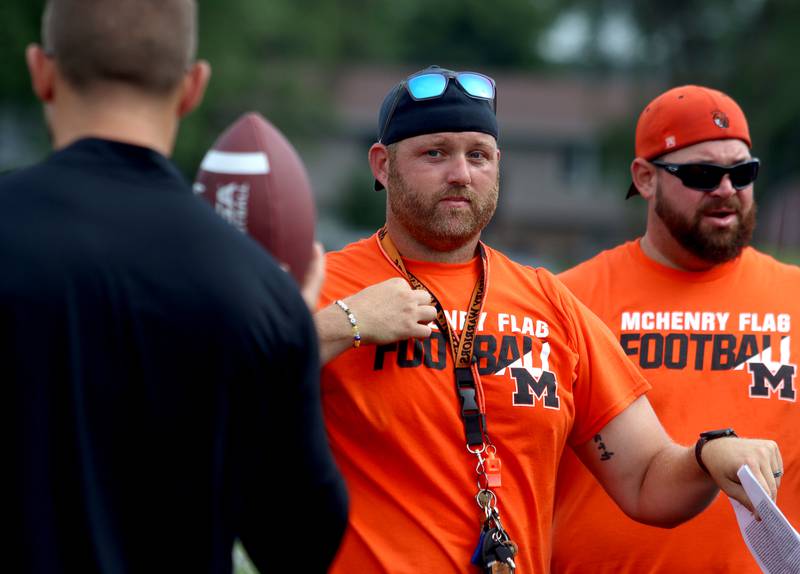 Flag football Head Coach Dennis Hutchinson, center, works with staff as the Chicago Bears and McHenry Community High School hosted a flag football clinic at McCracken Field Wednesday, July 31, 2024.