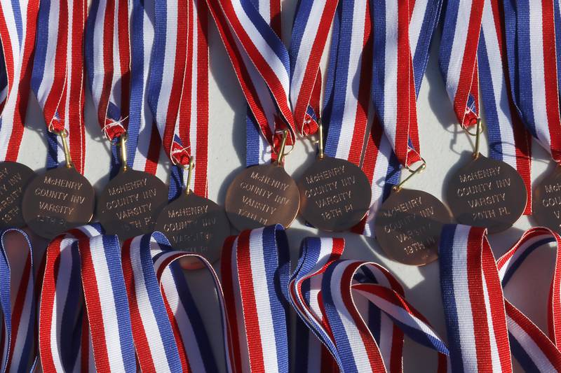 Varsity medals wait to be handed out at the McHenry County Cross Country Invite on Saturday, August 31, 2024, at McHenry Township Park in Johnsburg.