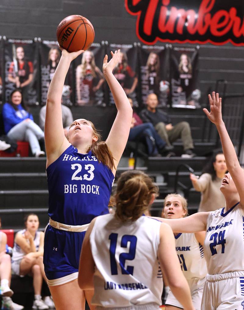 Hinckley-Big Rock's Sami Carlino gets a layup between two Newark defenders Thursday, Jan. 18, 2024, during the Little 10 girls basketball tournament at Indian Creek High School in Shabbona.