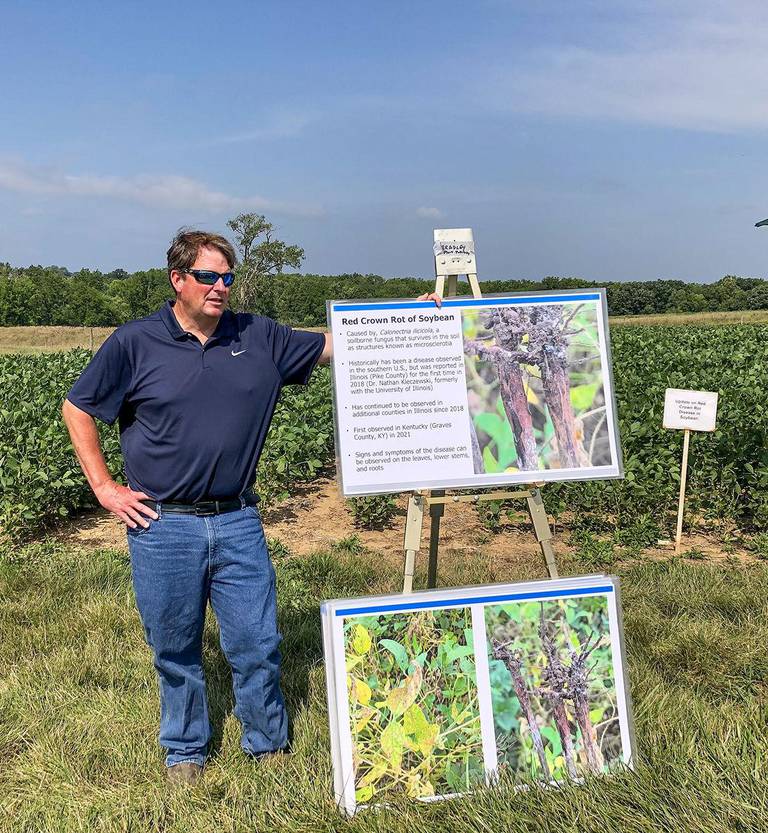 Carl Bradley, University of Kentucky plant pathologist who previously worked at the University of Illinois, shows farmers pictures of symptoms of red crown rot in soybeans during the U of I agronomy field day at the Orr Agricultural Center in Pike County. The soy disease continues to spread in Illinois after it was first identified here in 2018.