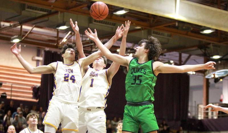 (Left to right) Downers Grove North’s Aidan Akkawi and Jake Riemer (center) and York’s Braden Richardson go after a rebound during a game at Downers Grove North on Friday, Jan. 19, 2024.