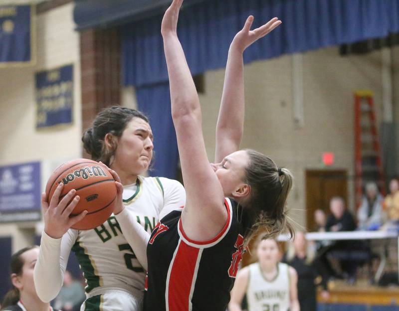 St. Bede's Ali Bosnich draws an offensive foul on Amboy's Emily Sachs during the Class 1A Regional final game on Friday, Feb. 16, 2024 at Marquette High School.