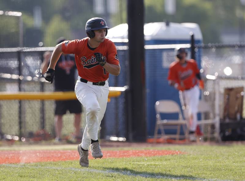 St. Charles East's Mac Paul (14) runs to first after getting a hit during the Class 4A York regional semi-final between Wheaton Warrenville South and St. Charles East in Elmhurst on Thursday, May 23, 2024.
