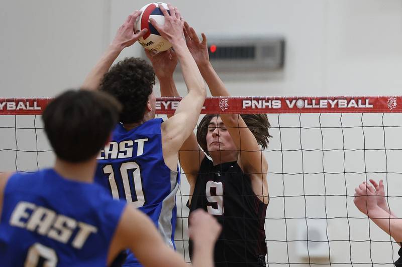 Plainfield North’s Easton Isaacson wins the battle at the net against Lincoln-Way East on Tuesday, April 2, 2024.