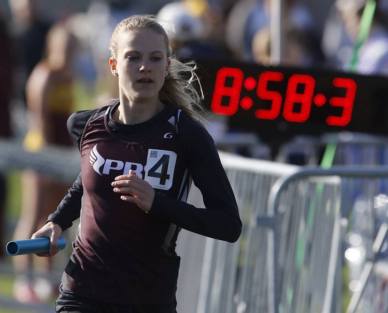 Prairie Ridge’s Rachel Soukup cruise to the finish line as she anchors the Prairie Ridge 4x800 meter relay team Friday, April 21, 2023, during the McHenry County Track and Field Meet at Cary-Grove High School.