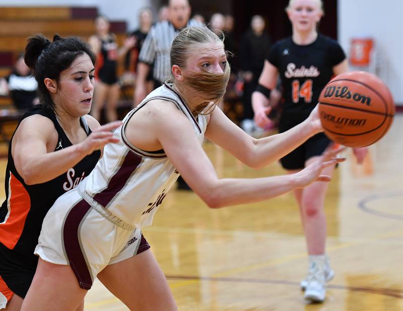 Montini's Victoria Matulevicius passes with St. Charles East's Alexis Maridis at her back during the Montini Christmas Tournament championship game on Dec. 29, 2023 at Montini Catholic High School in Lombard.