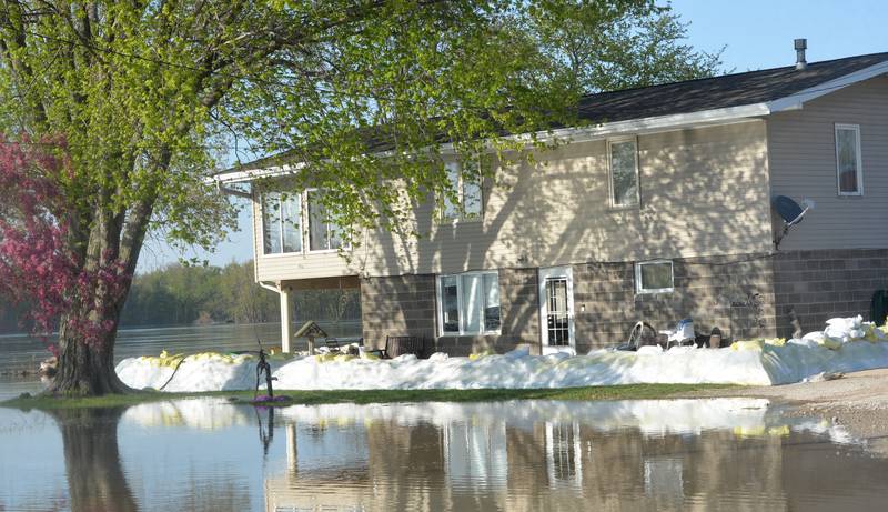 Floodwaters from the Mississippi River surround a home near the public boat docks in Albany on Thursday as water levels continued to rise.