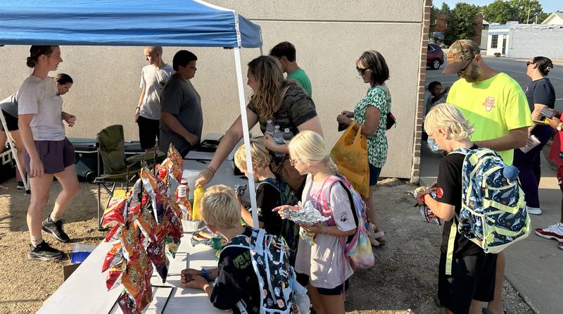 Boy Scout Troop 94 has a food booth at Prophetstown's Fourth Friday on Friday, July 26, 2024. The VanderMolan family of Morrison stopped by during the event. Pictured are Judah, Hannah, Isaiah, and Elijah and their mom and dad, Craig and Jennifer.