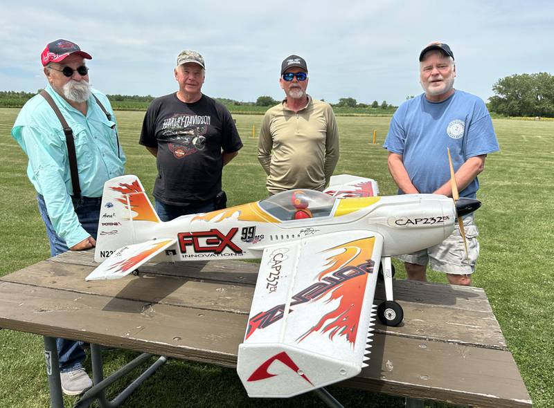 A few members of The Deer Park RC Flyers Club, (from left) Kake Krancic, Bernie Kahne, Larry Moore, and Bill Alleman pose for a photo by a model airplane on Monday, July 1, 2024 at the Model Airplane Field in Matthiessen State Park. The Deer Park RC Flyers radio-controlled aircraft club began flying remote controlled aircrafts since the 1970's. The club maintains the model airplane field and flys model airplanes at the site.