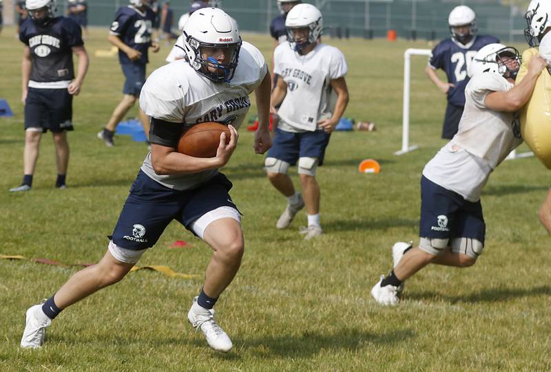 Cary-Grove’s Connor Anderson runs with the ball during football practice Thursday, June 29, 2022, at Cary-Grove High School in Cary.