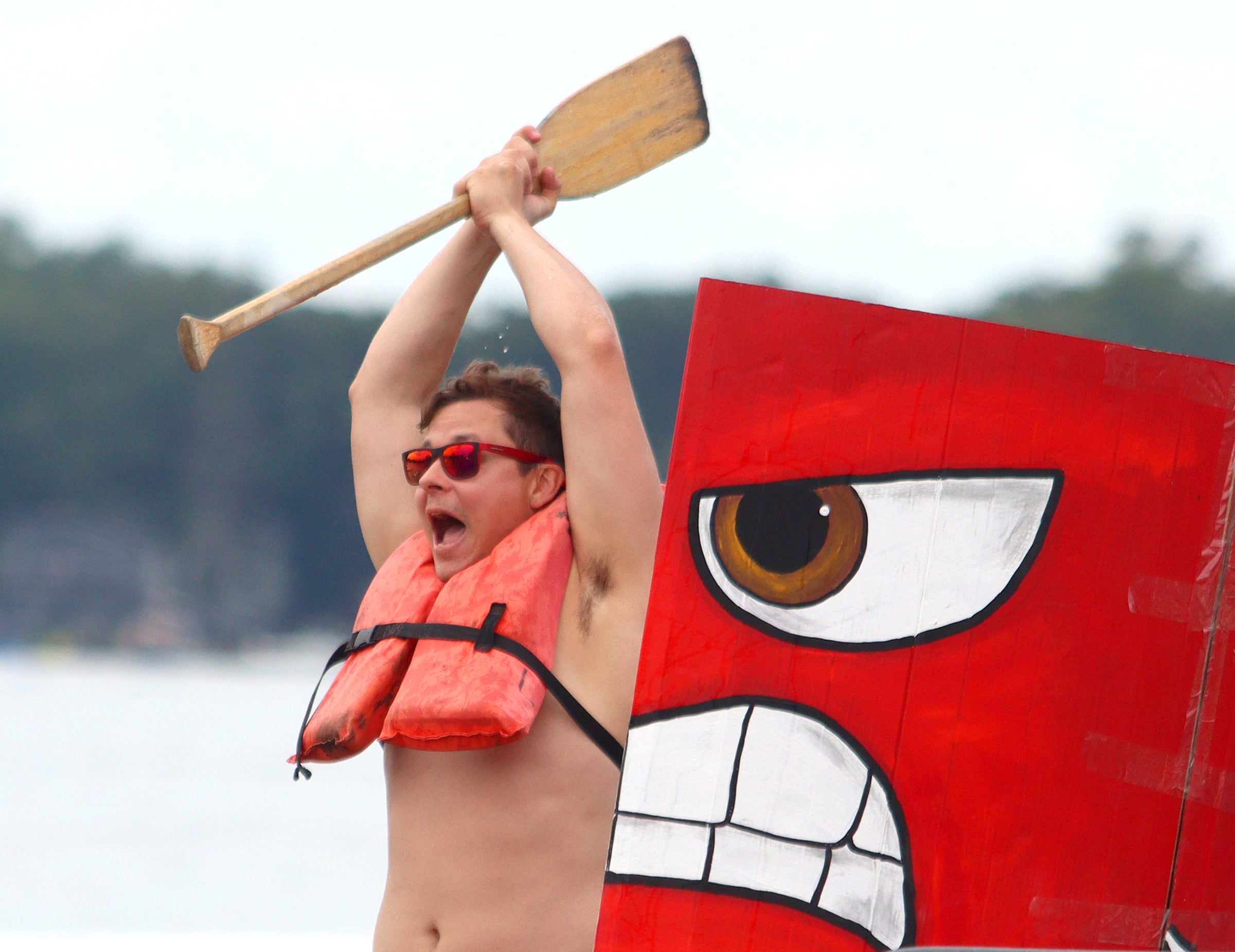 Jack Dwyer of the Brood XIII team howls as their Pixar-themed craft begins to take on water during the Cardboard Regatta on Crystal Lake Saturday. Dwyer is from Chicago.