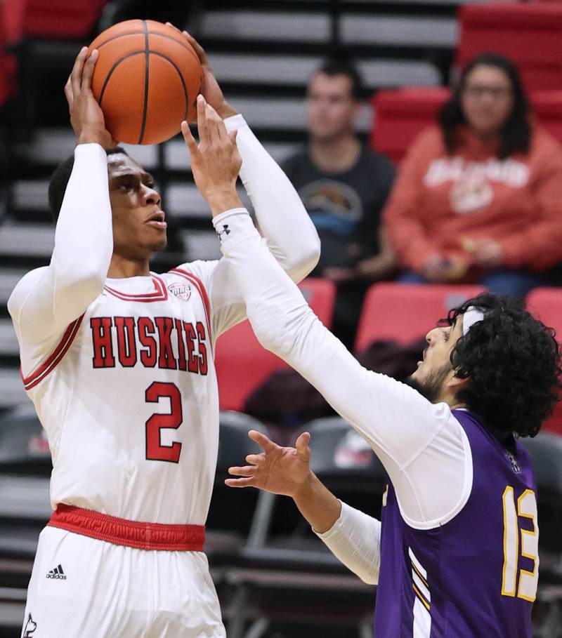 Northern Illinois Huskies guard Zarique Nutter shoots over Albany Great Danes guard Sarju Patel during their game Tuesday, Dec. 20, 2022, in the Convocation Center at NIU in DeKalb.