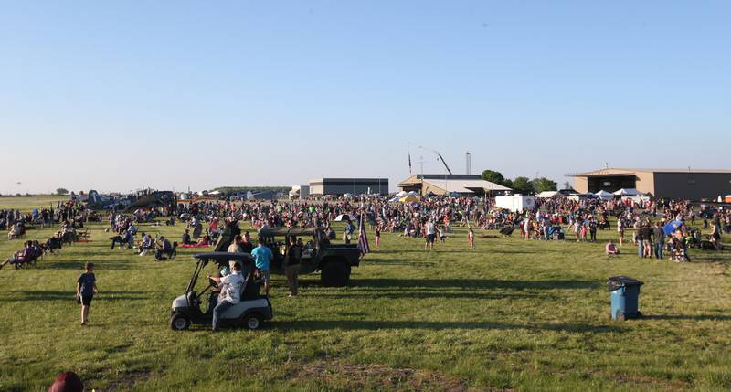 A gigantic crowd watches airplanes fly over during the annual TBM Avenger Reunion and Air Show on Friday, May 17, 2024 at the Illinois Valley Regional Airport in Peru.