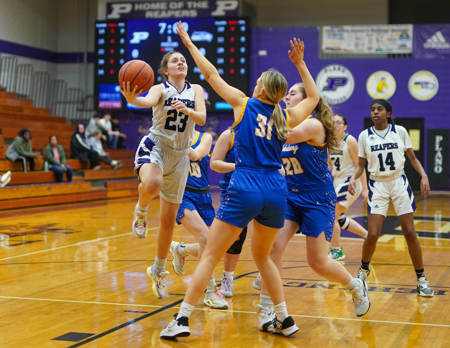 Plano's Josie Larson (23) drives to the hoop against Johnsburg's Sophie Person (31) during a basketball game at Plano High School on Tuesday, Jan 30, 2024.