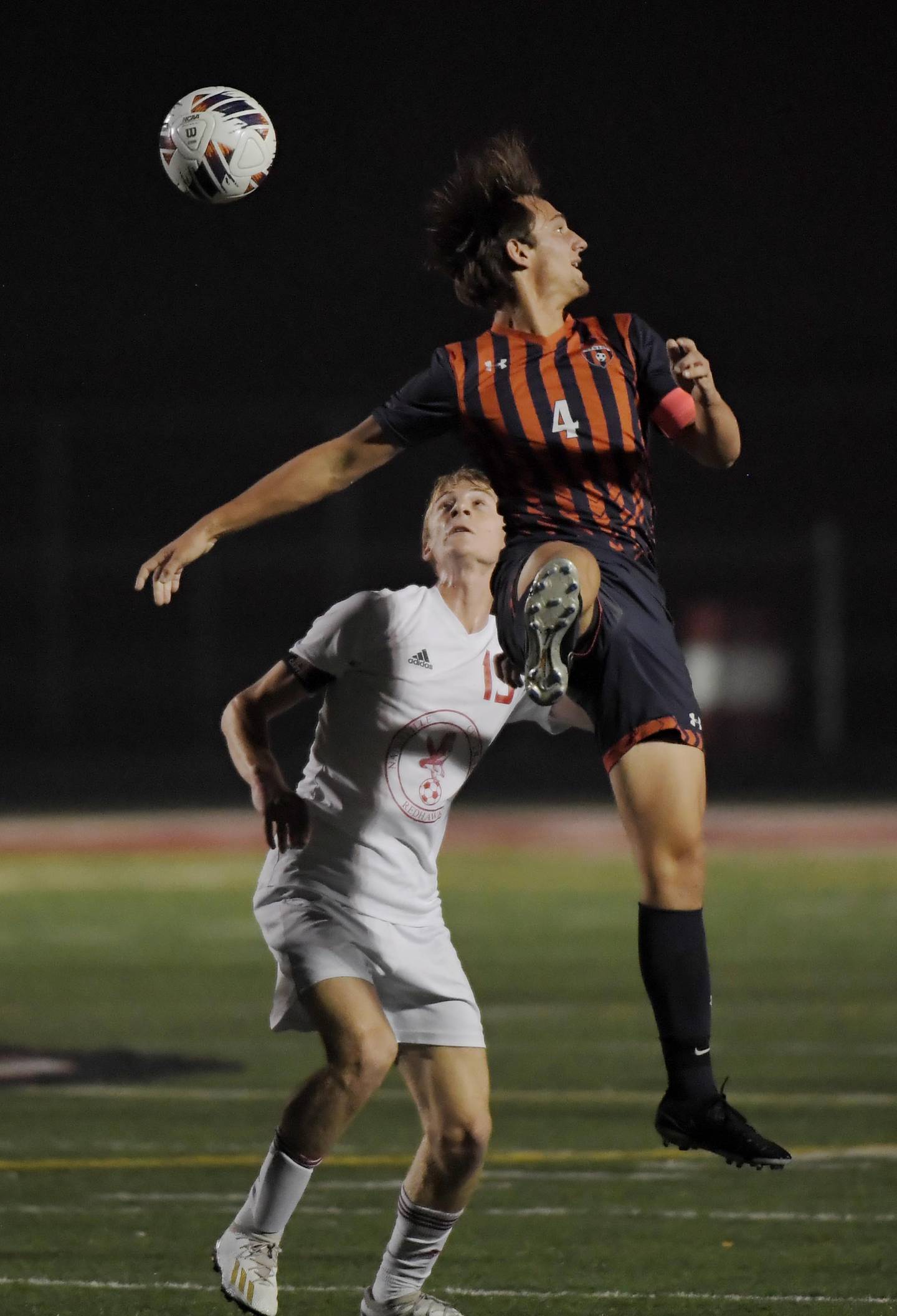 Naperville Central’s Alex Poole and Oswego’s Ryan Walsh compete for the ball in the Class 3A Plainfield North High School boys soccer sectional semifinal game in Plainfield on Wednesday, October 25, 2023.