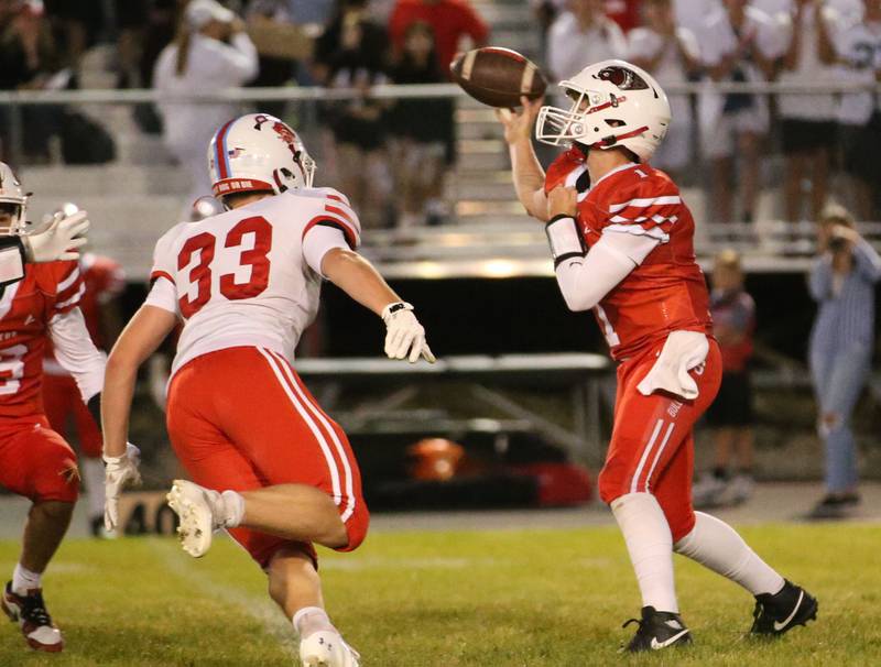 Streator quarterback Isaiah Weibel throws a pass as Ottawa's Cody Green puts pressure on him on Friday, Sept. 6, 2024 at Doug Dieken Stadium.