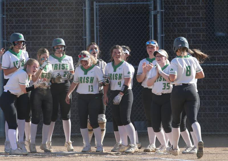 Seneca's Sam Vandevelde (right) runs into home while being greeted by her teammates after hitting a home run while playing against Putnam County on Thursday, April 13, 2023 at Seneca High School.