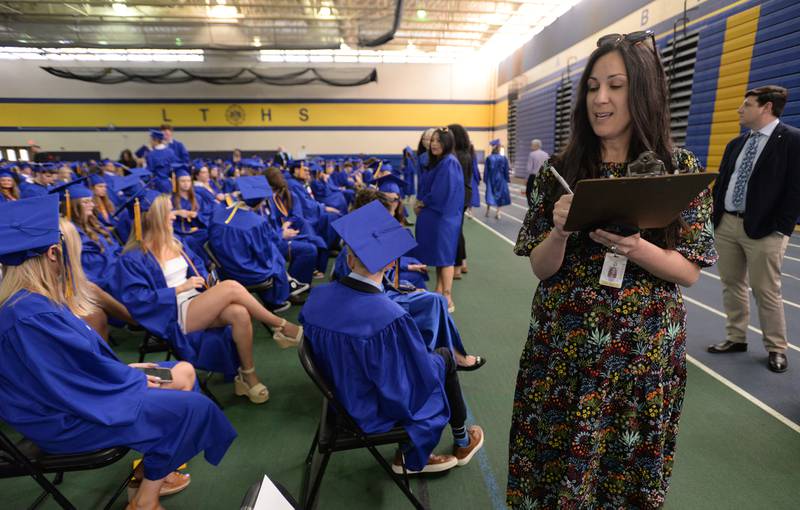 Division Chair of Lyons Township High School, Melissa Moore helps take attendance in preparation of their graduation ceremony Wednesday May 29, 2024.