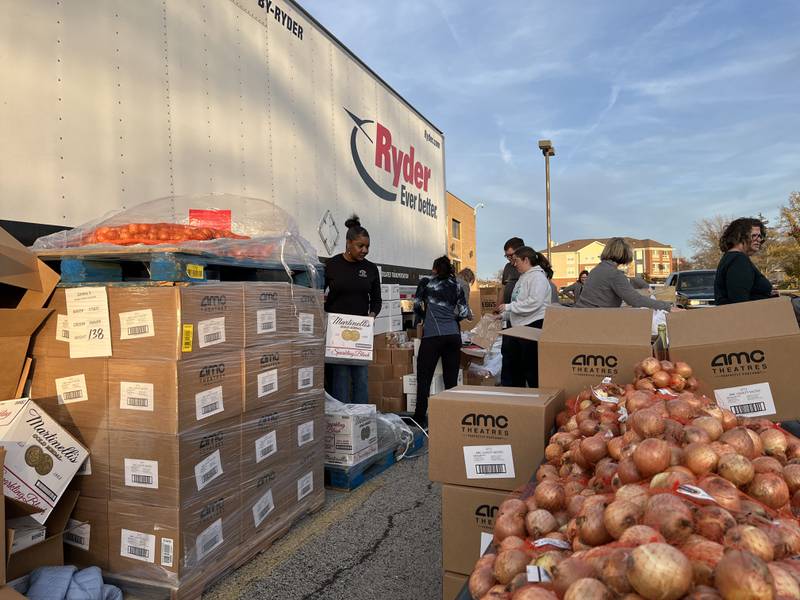 Volunteers assist with a mobile food pantry event on Monday, Nov. 6, 2023, outside of a Joliet veteran affairs clinic.