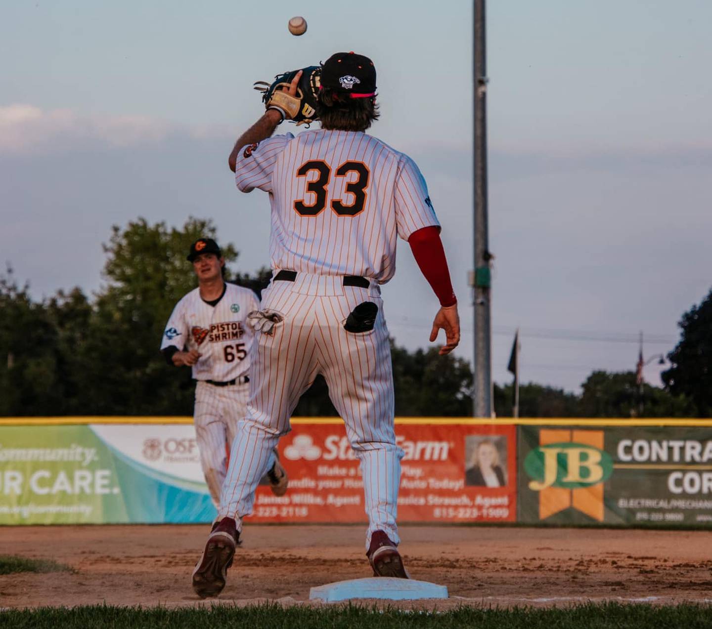The Illinois Valley Pistol Shrimp's Pambos Nicoloudes catches a ball at first base during a game against the Burlington Bees on Wednesday, June 19, 2024 at Schweickert Stadium in Peru.