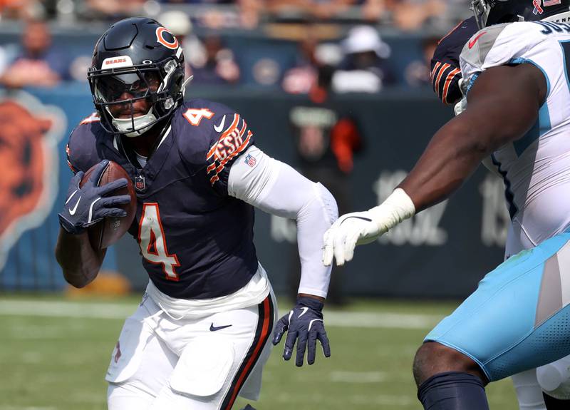 Chicago Bears running back D'Andre Swift runs by Tennessee Titans defensive tackle Sebastian Joseph-Day during their game Sunday, Sept. 8, 2024, at Soldier Field in Chicago.