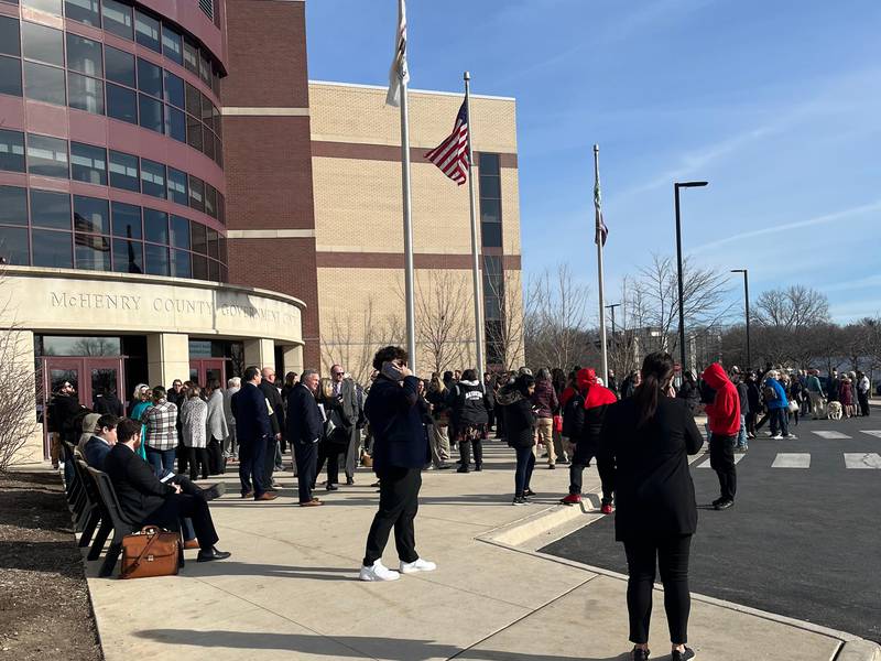 People standing outside after being evacuated from the McHenry County Courthouse Feb. 14, 2024.