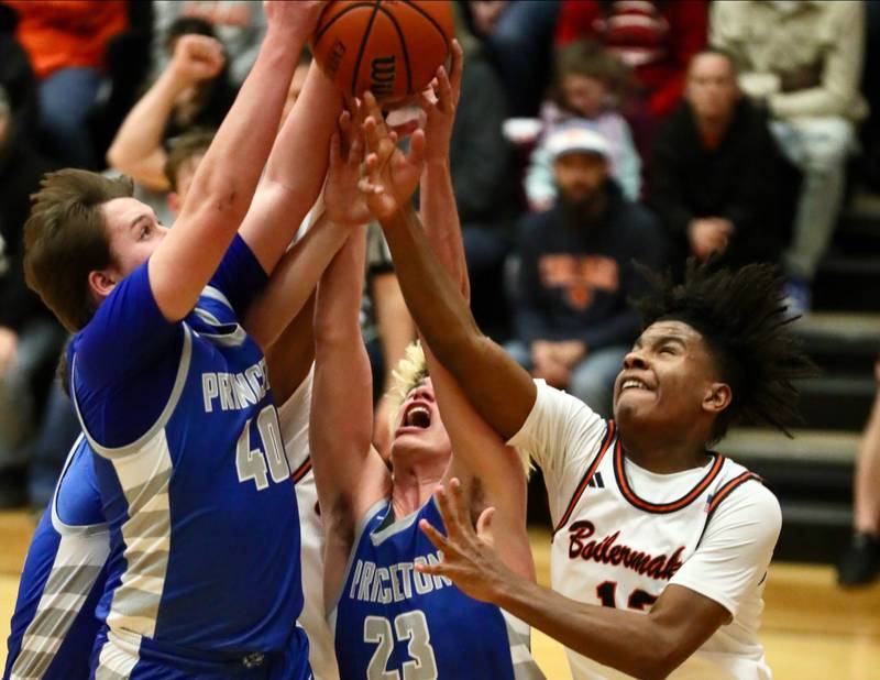 Princeton's Jordan Reinhardt (40) and Noah LaPorte (23) battles Kewanee's Braydon Conley for a rebound Tuesday night at Kewanee. The Tigers fell in overtime 64-59.