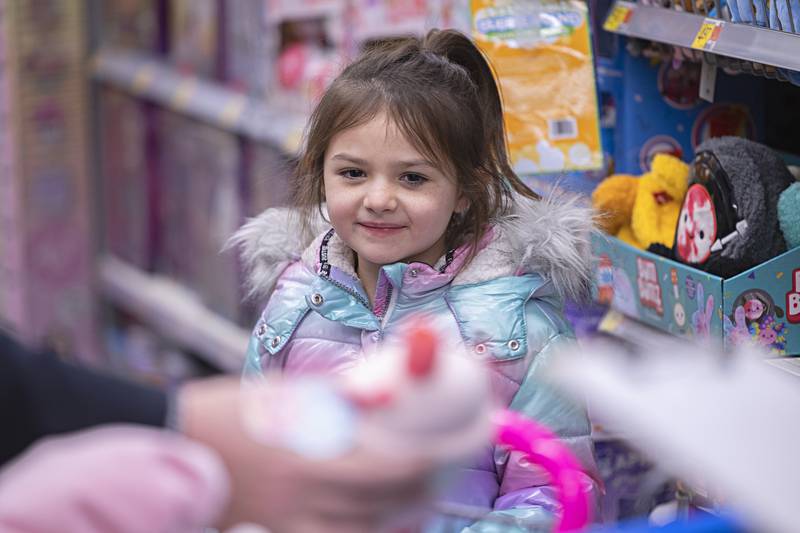 Zamorah Fordham smiles as she picks out gifts Saturday, Dec. 9, 2023 at Sterling Walmart. Fordham was shopping with officer Travis Ganther.