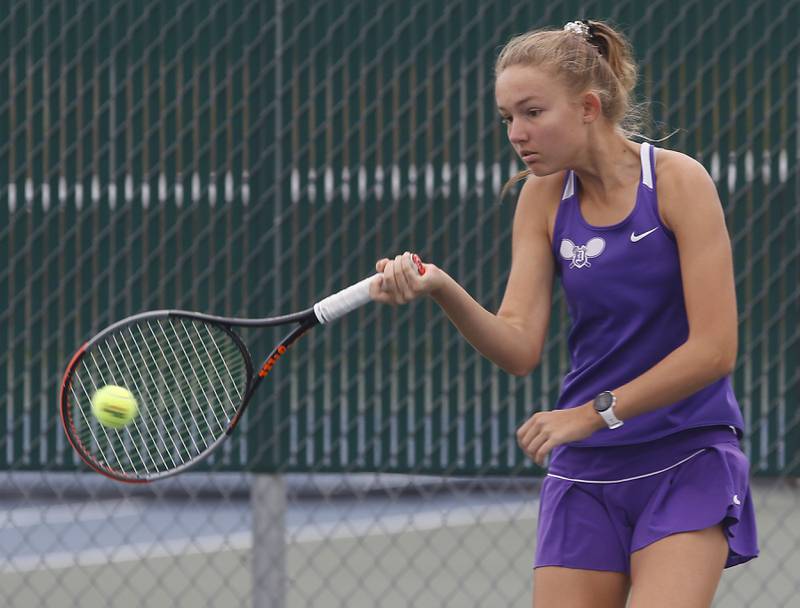 Dixon’s Grace Ferguson returns the ball Thursday, Oct. 19, 2023, during the first day of the IHSA State Girls Tennis Tournament at Hersey High School in Arlington Heights.