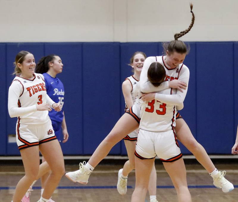 Crystal Lake Central's Addison Cleary jumps into the arms of her teammate, Katie Hamill, after Crystal Lake Central defeated Burlington Central in the IHSA Class 3A Woodstock Regional Championship girls basketball game on Thursday, Feb. 15, 2024, at Woodstock High School.