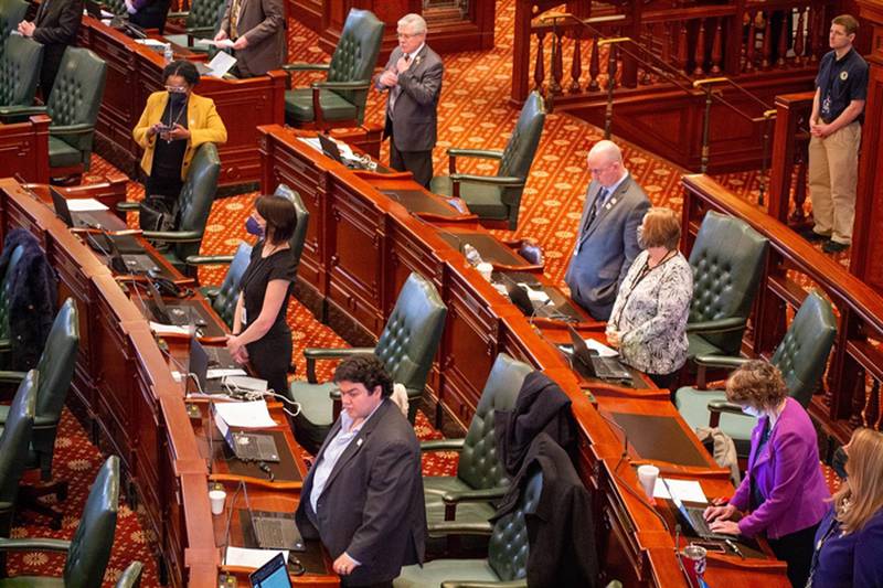 Democratic lawmakers are pictured on the House floor Tuesday after masks were made optional through a vote on House rules.