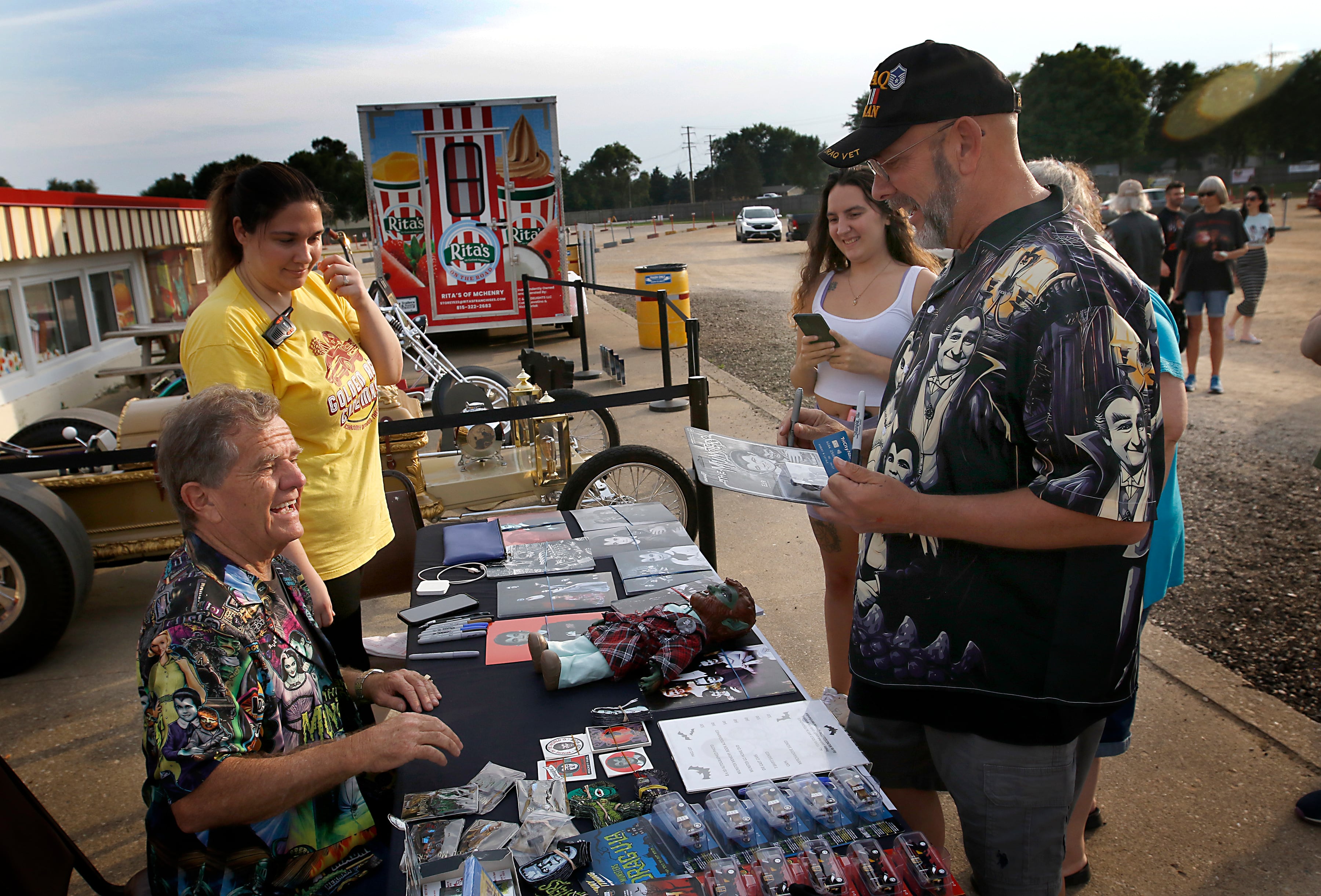 Butch Patrick, who played Eddie Munster on the 1960s show “The Munsters” talks with Bob Leisle of Oak, Creek, Wisconsin, as he signs autographs, Wednesday, Aug. 14, 2024, during an appearance at the McHenry Outdoor Theater.