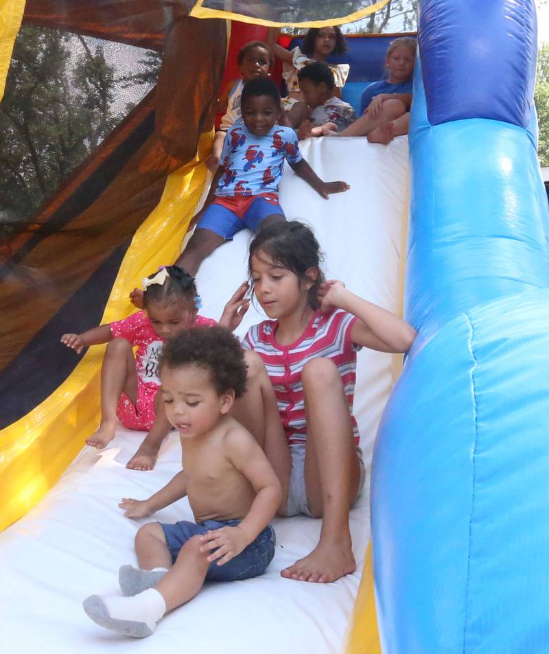 Kids play in a bounce house during the Juneteenth event on Wednesday June 19, 2024 at Kirby Park in Spring Valley.