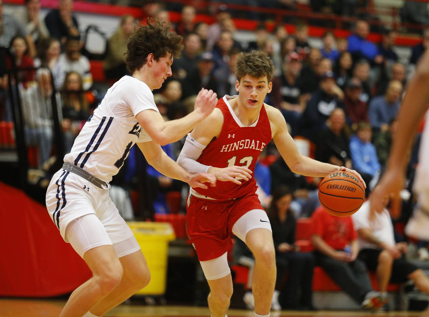 Hinsdale Central's Ben Oosterbaan (12) drives to the basket during the Hinsdale Central Holiday Classic championship game between Oswego East and Hinsdale Central high schools on Thursday, Dec. 29, 2022 in Hinsdale, IL.