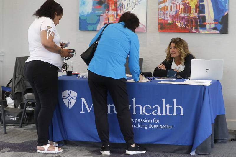 Belinda Herstad, the Director of Talent Acquisition and Workforce Planning for Mercyhealth, talks with job applicants Wednesday, June 28, 2023, at the at the Holiday Inn in Crystal Lake. Mercyhealth was holding a job fair for the new Mercyhealth Hospital and Physician Clinic in Crystal Lake.